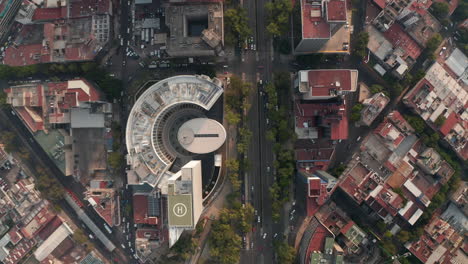 Top-down-view-of-streets-in-Mexico-city.-Cars-driving-in-streets-in-low-traffic-hours.-Drone-camera-slowly-moving-forward.