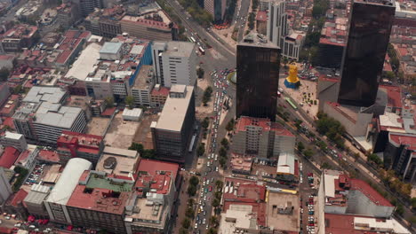 High-angle-aerial-view-of-heavy-traffic-in-streets-of-downtown.-Drone-flying-forwards-and-camera-tilting-down.-Mexico-city,-Mexico.