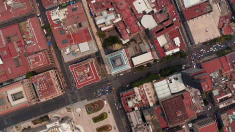Aerial-birds-eye-overhead-top-down-view-of-buildings-in-downtown-with-Torre-Latinoamericana-in-center.-Rotating-and-slowly-zooming-in-footage.-Mexico-city,-Mexico.