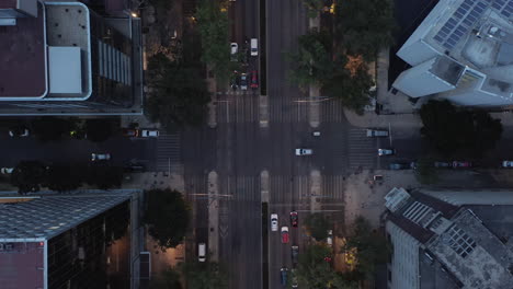 Aerial-birds-eye-overhead-top-down-view-of-traffic-on-crossroad.-Zooming-out-evening-view-of-cars-driving-on-street.-Mexico-city,-Mexico.