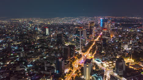 Aerial-hyperlapse-view-of-urban-modern-Mexico-City-center-with-tall-skyscrapers-at-night