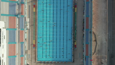 Overhead-Birds-Eye-Top-Down-Aerial-View-of-Swimmers-training-doing-lanes-in-Blue-Pool,-SEPTEMBER-9th-2020