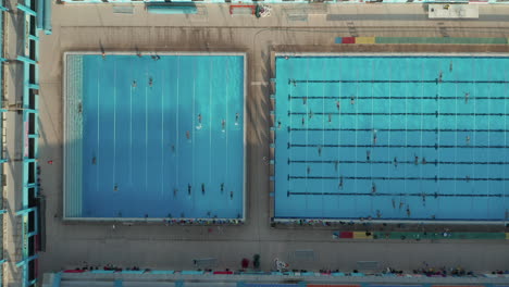 Swimmers-training-doing-Laps-in-Blue-Pool,-Epic-Overhead-Top-Down-Birds-Eye-Perspective,-SEPTEMBER-9th-2020
