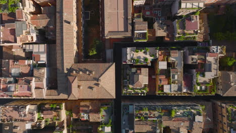 Top-down-panning-footage-of-various-buildings-with-rooftop-terraces-and-green-plants.-Fly-above-town-development-in-urban-borough.-Rome,-Italy