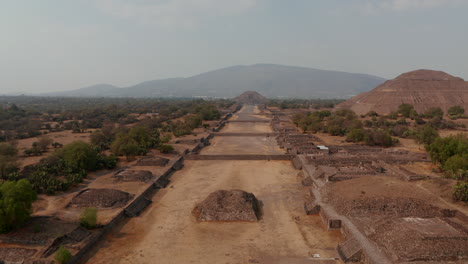 Aerial-view-of-Avenue-of-Dead-in-Teotihuacan-complex-with-Sun-and-Moon-pyramids.-Drone-view-of-Teotihuacan-Pyramids-and-Avenue-of-the-Dead-in-Mexico-Valley-with-Citadel-complex