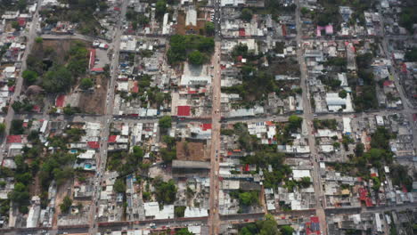 Aerial-birds-eye-overhead-top-down-panning-view-of-urban-neighbourhood.-Tilt-up-reveal-of-town-outskirt.-Valladolid,-Mexico