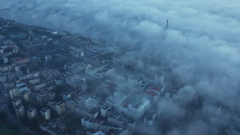 Aerial-footage-of-mist-above-river-at-cable-stayed-Swietokrzyski-Bridge.-Romantic-morning-view-of-urban-neighbourhood.-Warsaw,-Poland