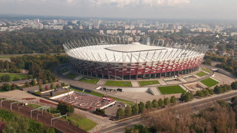 Slide-and-pan-footage-of-modern-National-stadium.-Park-and-housing-estate-in-background.-Warsaw,-Poland