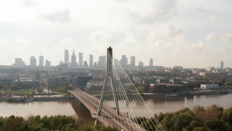 Slide-and-pan-shot-of-bridge-over-Vistula-river-with-reversed-Y-shape-pillar.-Cityscape-against-bright-sky-in-background.-Warsaw,-Poland