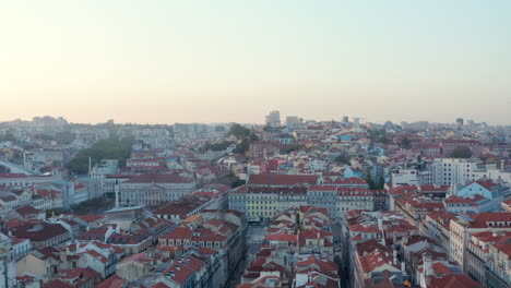 Aerial-view-of-colorful-residential-apartment-houses-with-red-rooftops-in-traditional-European-Lisbon-city-center-in-Portugal