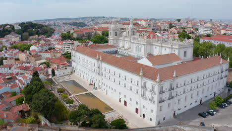 Aerial-establishing-orbit-of-white-monastery-of-Sao-Vicente-de-Fora-church-building-on-the-hill-in-city-center-of-Lisbon,-Portugal