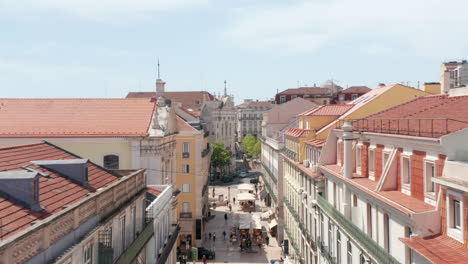 Drone-camera-flying-forwards-above-Rua-Garrett-street.-Aerial-view-of-principal-shopping-street-in-Chiado.-Lisbon,-capital-of-Portugal.