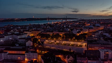 Aerial-day-to-night-hyperlapse-of-residential-buildings-and-tourist-landmarks-in-Lisbon-city-center