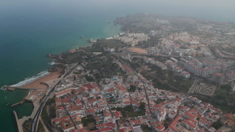 Astonishing-aerial-drone-view-of-Lagos-city-landscape-with-paradisiac-coastline-in-distance,-Algarve,-Portugal,-tilt-up,-day