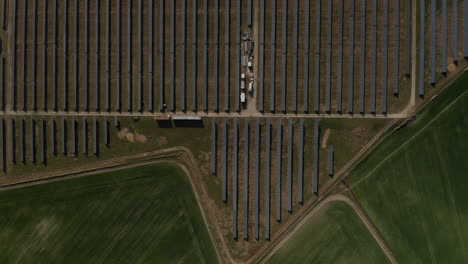 Birds-eye-shot-of-solar-park.-Fly-high-above-photovoltaic-cell-for-producing-renewable-energy.-Green-energy,-ecology-and-carbon-footprint-reduction-concept