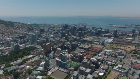 Aerial-panoramic-footage-of-downtown-buildings-in-city.-Sea-bay-with-harbour-in-background.-Cape-Town,-South-Africa