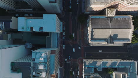 Aerial-birds-eye-overhead-top-down-panning-view-of-buildings-along-street-in-city-centre.-Cars-passing-through-crossroads.-Cape-Town,-South-Africa