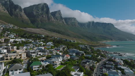 Guesthouses-and-residencies-in-suburb-on-seaside-under-majestic-rocky-mountain-ridge.-Cape-Town,-South-Africa