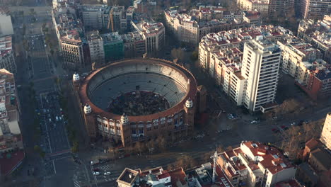 Aerial-footage-of-historic-round-La-Monumental-arena.-People-on-event-inside-arena.-Barcelona,-Spain