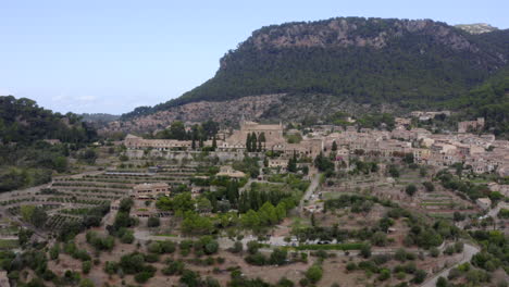 AERIAL:-View-on-Valldemossa-on-Mountains-in-Jungle-Forest-on-Tropical-Island-Mallorca,-Spain-on-Sunny-Day-Vacation,-Travel,-Sunny
