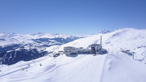 Backwards-ascending-footage-of-winter-mountain-scenery.-Sport-in-nature-on-sunny-day.-Snow-covered-landscape.-Laax,-Switzerland