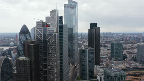 Slide-and-pan-footage-of-tall-modern-office-buildings-with-glossy-glass-facades.-City-financial-hub.-London,-UK