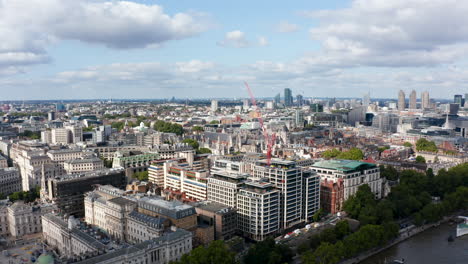 Panorama-curve-footage-of-buildings-in-city-district.-Aerial-view-on-old-houses,-Historic-Royal-Courts-of-Justice-buildings-complex.-Modern-skyscrapers-in-background.-London,-UK