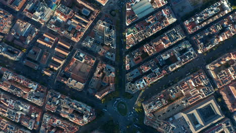 Aerial-birds-eye-overhead-top-down-view-of-traffic-in-city-centre.-Vehicles-driving-in-streets-and-passing-crossroads.