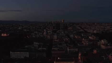 Slide-and-pan-footage-of-cityscape-at-dusk.-Evening-aerial-panoramic-shot-of-town-development-after-sunset.