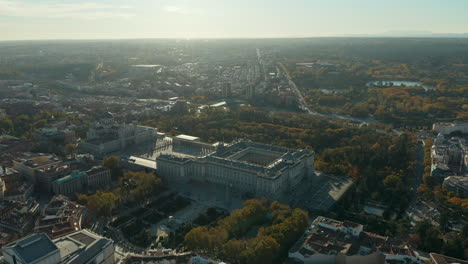 Slide-and-pan-footage-of-large-building-on-Royal-Palace-and-Almudena-Cathedral.-Aerial-view-against-sunshine.