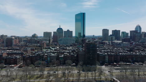 Fly-over-busy-trunk-road-on-waterfront-and-buildings-in-residential-borough.-Modern-high-rise-office-towers-in-background.-Boston,-USA