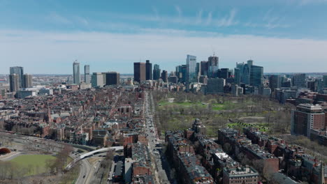 Aerial-ascending-footage-of-town-development.-Classical-townhouses-with-apartments-contrasting-with-modern-high-rise-office-towers-in-background.-Boston,-USA