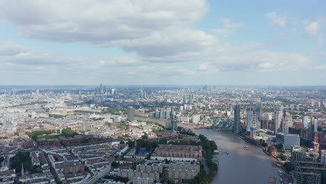 Aerial-panoramic-view-of-town.-Residential-neighbourhoods-are-interspersed-with-commercial.-Housing-estates-and-tall-office-buildings.-London,-UK
