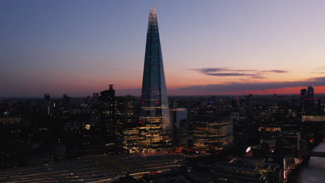 Elevated-view-of-iconic-Shard-skyscraper-after-sunset.-Tall-modern-office-building.-Colourful-twilight-sky.-London,-UK