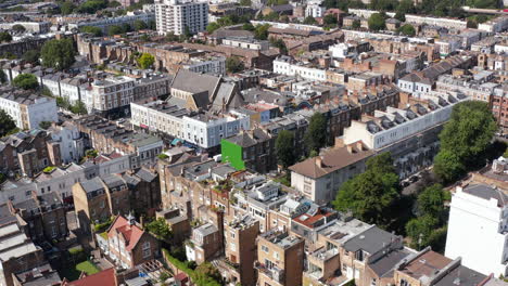 Aerial-view-of-variety-of-houses-in-residential-town-district.-Rows-of-buildings-along-streets.-London,-UK