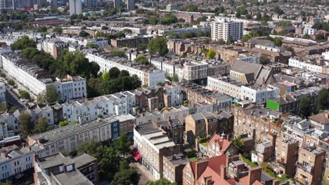 Forwards-fly-above-rows-of-houses-in-urban-neighbourhood.-Aerial-view-of-streets-and-homes.-London,-UK