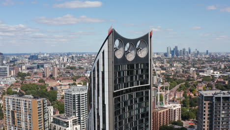 Fly-around-top-of-modern-design-Strata-skyscraper-at-Elephant-and-Castle.-Cityscape-in-background.-London,-UK