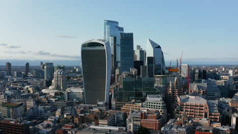 Slide-and-pan-shot-of-iconic-Walkie-Talkie-skyscraper-and-other-futuristic-tall-modern-buildings-in-City-business-hub.-London,-UK