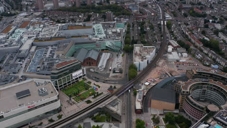 High-angle-view-of-large-shopping-and-entertainment-centre-Westfield.-Railway-tracks-leading-around.-London,-UK