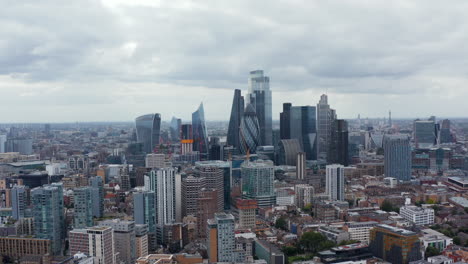 Slide-and-pan-shot-of-business-hub.-Iconic-modern-skyscrapers-in-City-district-from-east.-Overcast-sky.-London,-UK