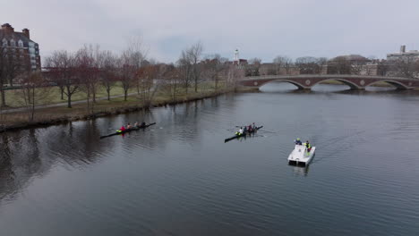 Aerial-view-of-two-sports-rowing-boats-waiting-for-start-during-training-on-Charles-river.-Orbit-shot.-Boston,-USA