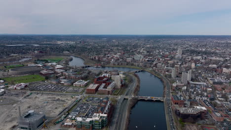 Aerial-panoramic-shot-of-large-city.-Charles-river-flowing-through-Cambridge-around-Harvard-University-site.-Boston,-USA