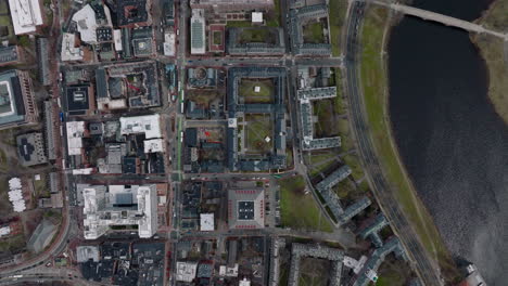 Top-down-panning-shot-of-buildings-and-road-along-Charles-river.-Harvard-University-campus-complex.-Boston,-USA