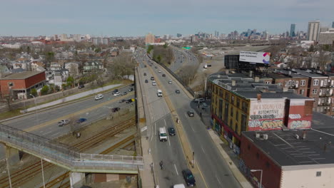 Transport-infrastructure-in-urban-neighbourhood.-Vehicles-driving-in-road-bridge-over-railway-tracks-and-highway.-Boston,-USA