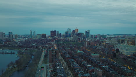Aerial-panoramic-descending-footage-of-Back-Bay-borough-at-dusk.-Cityscape-view-downtown-skyscrapers-in-distance.-Boston,-USA