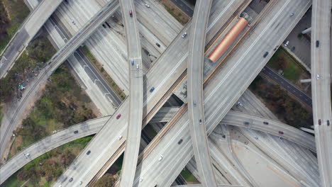 AERIAL:-Spectacular-Overhead-Shot-Rising-up-over-Judge-Pregerson-Interchange-showing-multiple-Roads,-Bridges,-Highway-with-little-car-traffic-in-Los-Angeles,-California-on-Beautiful-Sunny-Day