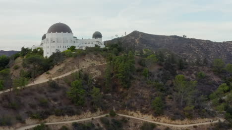 AERIAL:-Griffith-Observatory-with-Flight-over-Hollywood-Hills-on-Cloudy-Overcast-Day-in-Los-Angeles