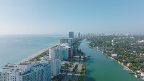 Aerial-footage-of-row-of-modern-multistorey-buildings-on-sea-coast.-Luxury-apartment-houses-or-hotels.-Miami,-USA