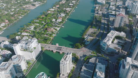 Aerial-footage-of-roads-and-bridges-over-water-in-urban-neighbourhood.-Mixture-of-tall-buildings-and-family-houses.-Miami,-USA