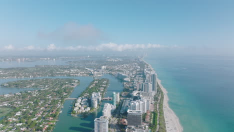 Sunny-day-on-sea-coast.-luxury-apartment-houses-in-urban-neighbourhood,-aerial-panoramic-footage.-Miami,-USA